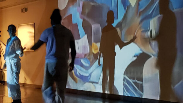 Dancers Frankie Freeman and Paul Jenkins move to the music in front of projected artwork by Atlanta muralist Krista M. Jones in the first concert of the 2024 SoundNOW Festival. (credit: Davida Cohen)