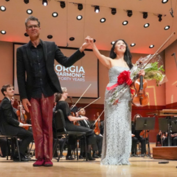 Composer Michael Kurth and violinist Helen Hwaya Kim take a bow after the premiere of Kurth's "Violin Concerto" with the Georgia Philharmonic. (credit: Eric Burkard)