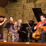 The Vega Quartet, L-R: Jessica Shuang Wu, Emily Daggett Smith, Guang Wang, and Joseph Skerik perform “Spring” from Vivaldi’s ‘Four Seasons.’ Elizabeth Pridgen, at the piano, is not performing in this piece. (credit: Mark Gresham)
