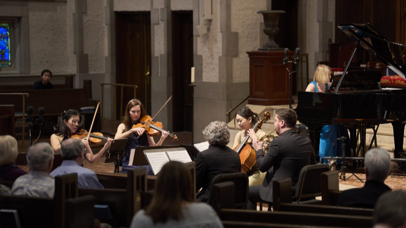 Clockwise from left (foreground): violinist Helen Hwaya Kim, violist Catherine Lynn, cellist Isabel Kwon, hornist Ryan Little, and carinetist Jesse McCandless, with pianist Elizabeth Pridgen (backgtound), performing the world premiere of Andrea Casarrubios’ ‘Sextet.’ (credit: Chris Helton)