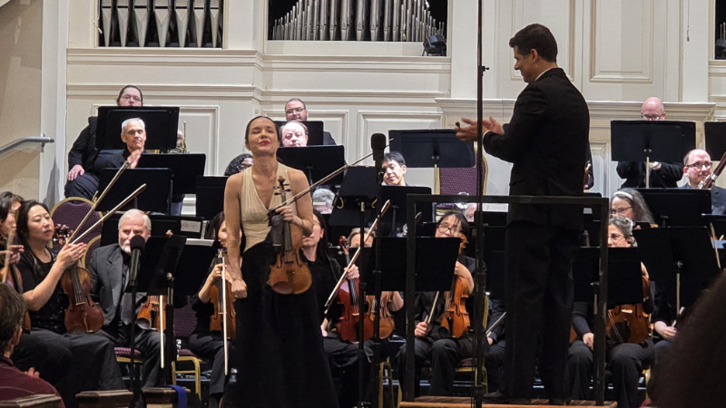 Violinist Emily Daggett Smith takes a bow after soloing in Bruch's 'Violin Concerto' with conductor Paul Bhasin and the DeKalb Symphony Orchestra. (credit: William Ford)