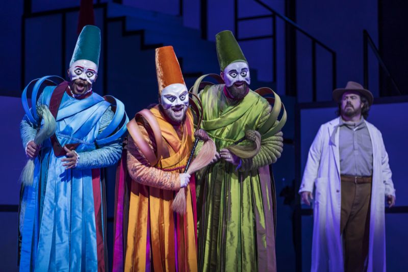 Ping, Pang, and Pong, the court ministers, warn Calaf against testing himself against the Princess’s riddles. Terrence Chin-Loy (left) as Pong; Eleomar Cuello (center) as Ping; and Wayd Odle as Pang. Jonathan Burton appears in the right background as Prince Calaf. (credit: Raftermen)