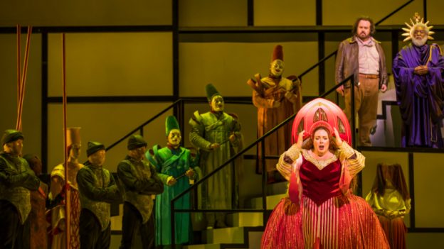 Angela Meade (front right) as Princess Turandot. Behind her, on the top step, Jonathan Burton, wearing a leather jacket, as Prince Calaf, and Steven Cole, in purple robes, as Emperor Altoum. (credit: Raftermen)