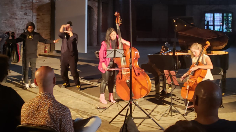 Bassist Emily Koh and cellist Laura Usiskin (right) performance of Afred Schnittke’s ‘Hymn II’ wit movement artists (background left). (credit: Davida Cohen)