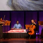 Chitravina Ravikiran playing the chitravina, a 21-string fretless slide lute, at the center of the Apollo Chamber Players’ ‘Tranquility’ program at Zilkha Hall, Oct. 3, 2026. (credit: Lynn Lane)
